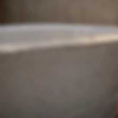 Professional refinisher applying new coating to a bathtub