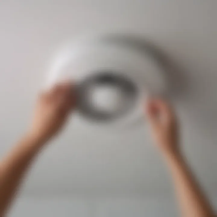 A homeowner reviewing NuTone bathroom fan installation instructions