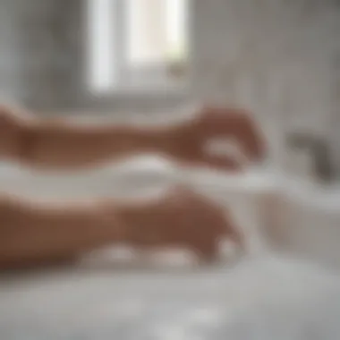 A person carefully applying sealant to the edges of a bathtub